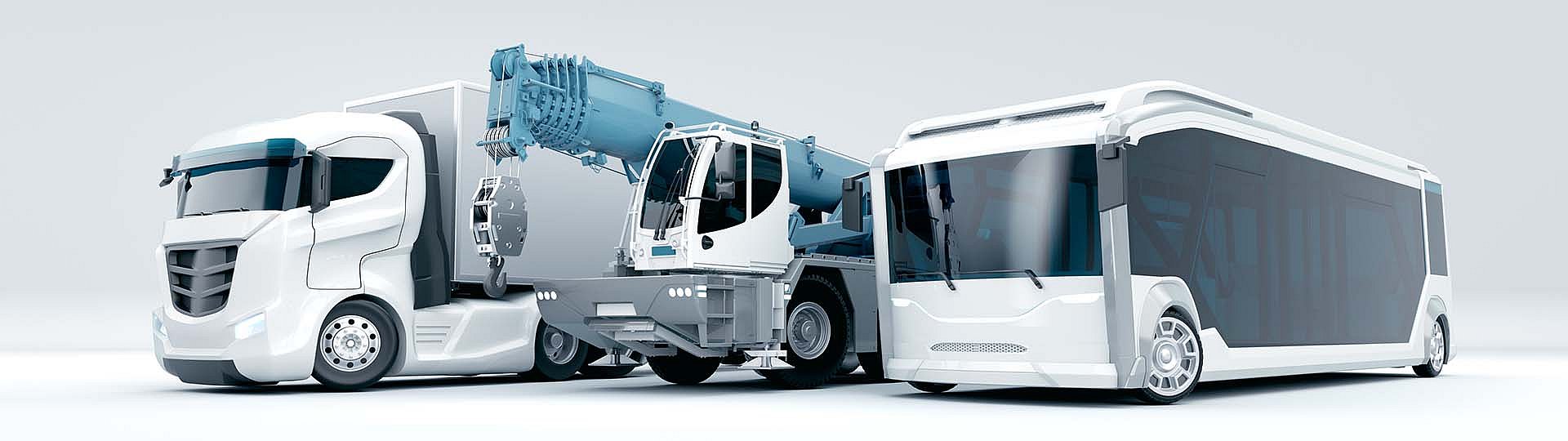 Composition de trois véhicules électriques : on peut voir un camion électrique, un camion-grue électrique et un bus électrique
